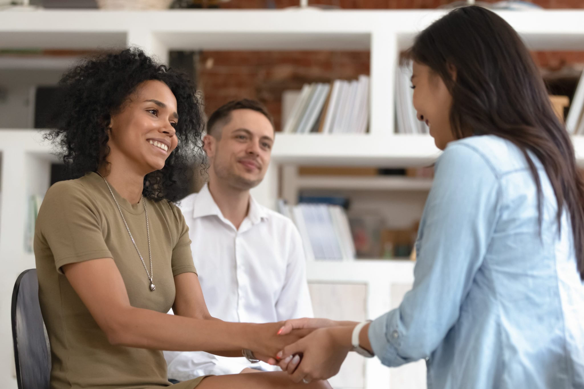 Asian,And,African,Women,Holding,Hands,During,Group,Therapy,Session,