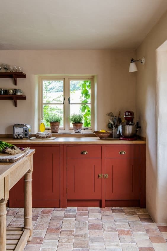Red-Orange Brick kitchen with brass cup handles and traditional clay tiled floor