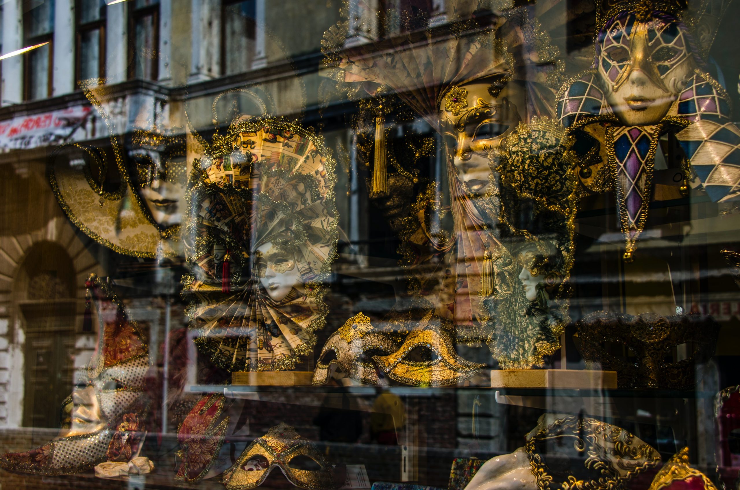 carnevale masks in a window to see when travel in italy in february