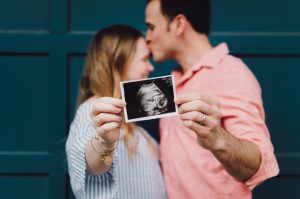 couple holding an ultrasound being pregnant in Italy
