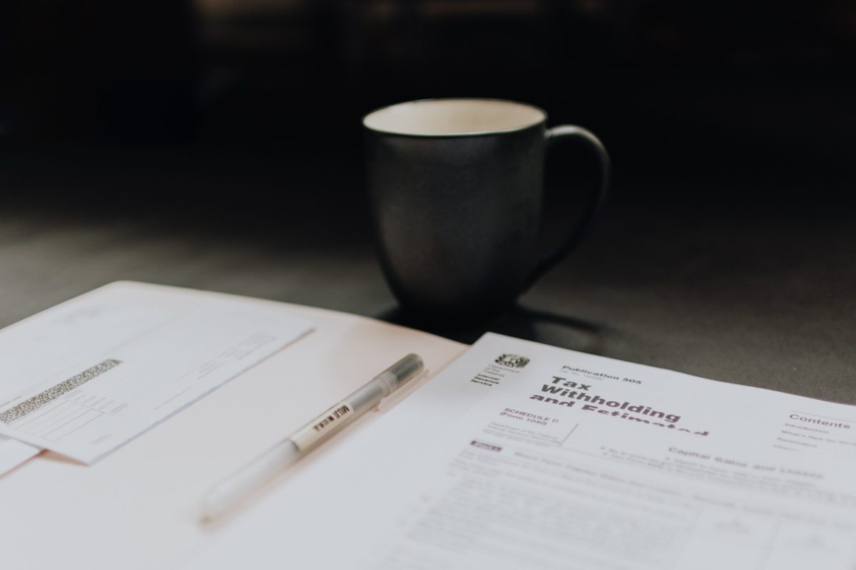 filing expat taxes in italy by hand with a cup of coffee