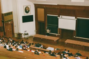 students in a large wooden classroom studying in Italy for Italian student visa