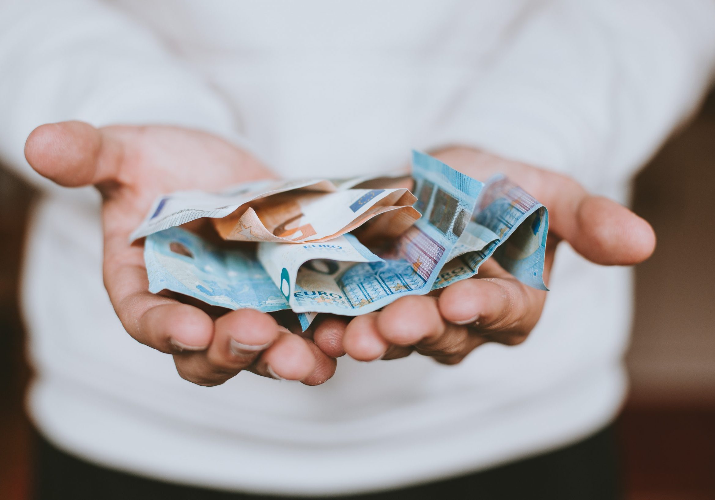 euros in hand outstretched asking is italy expensive