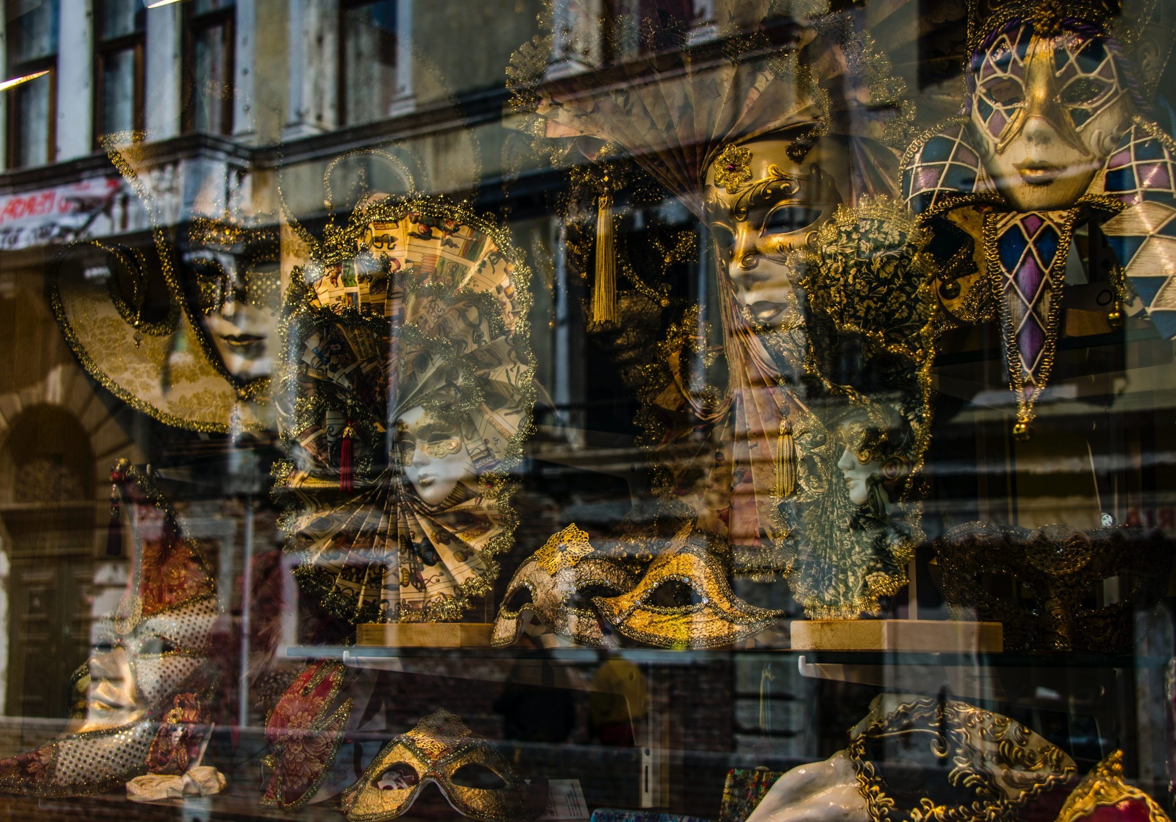 carnevale masks in a window to see when travel in italy in february