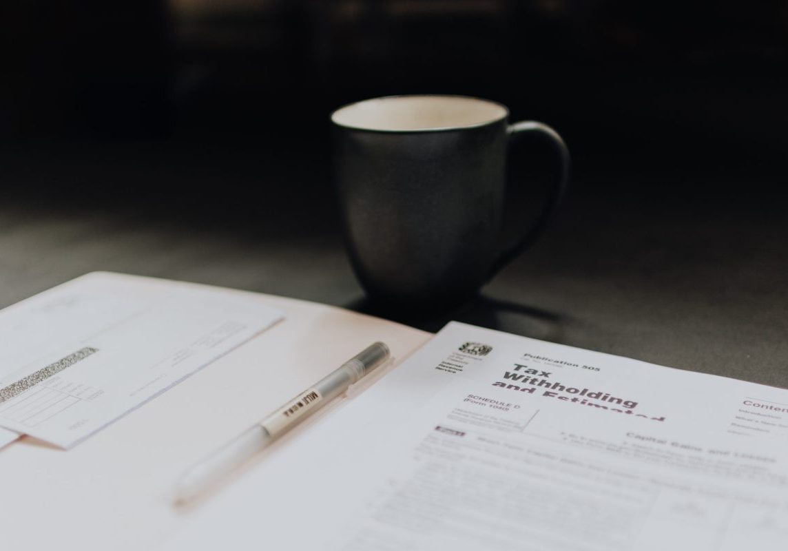 filing expat taxes in italy by hand with a cup of coffee