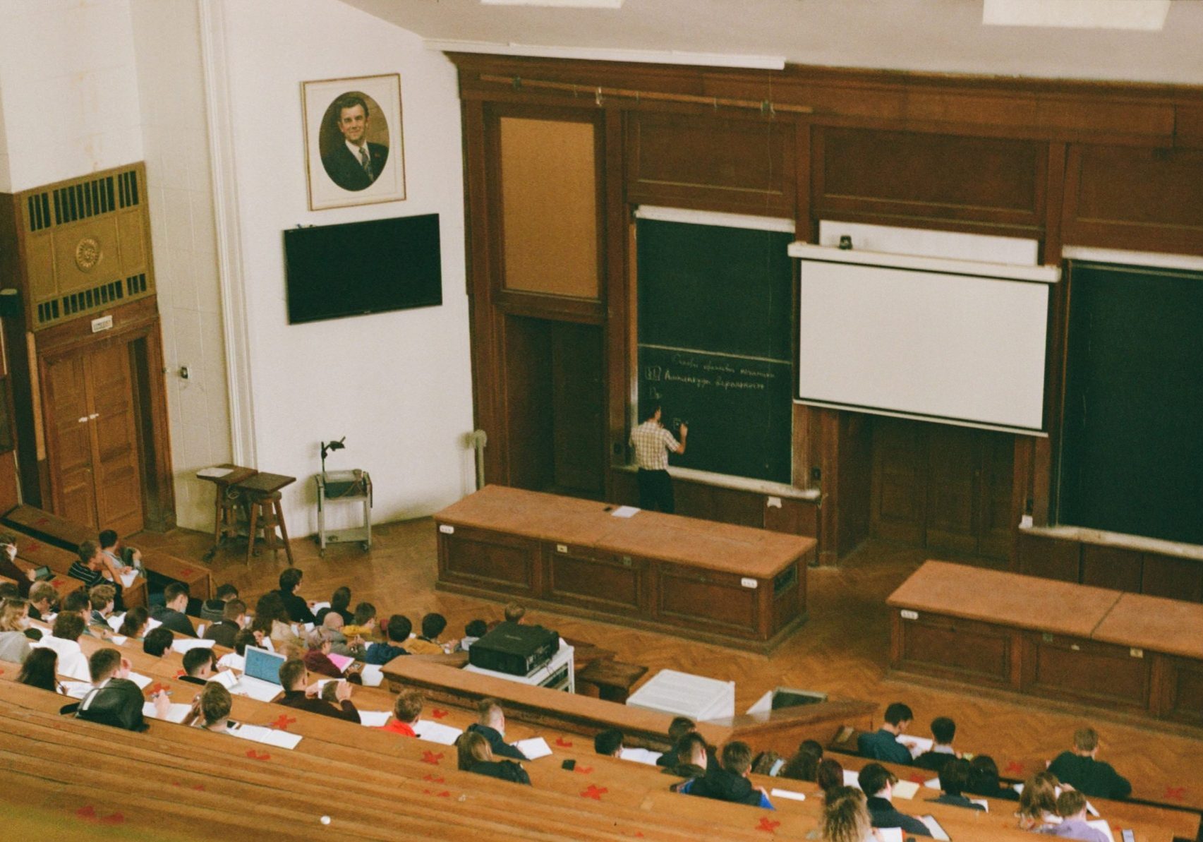 students in a large wooden classroom studying in Italy for Italian student visa