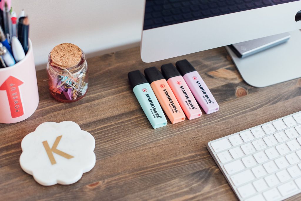 Desk with highlighter pens, coaster, keyboard and Mug