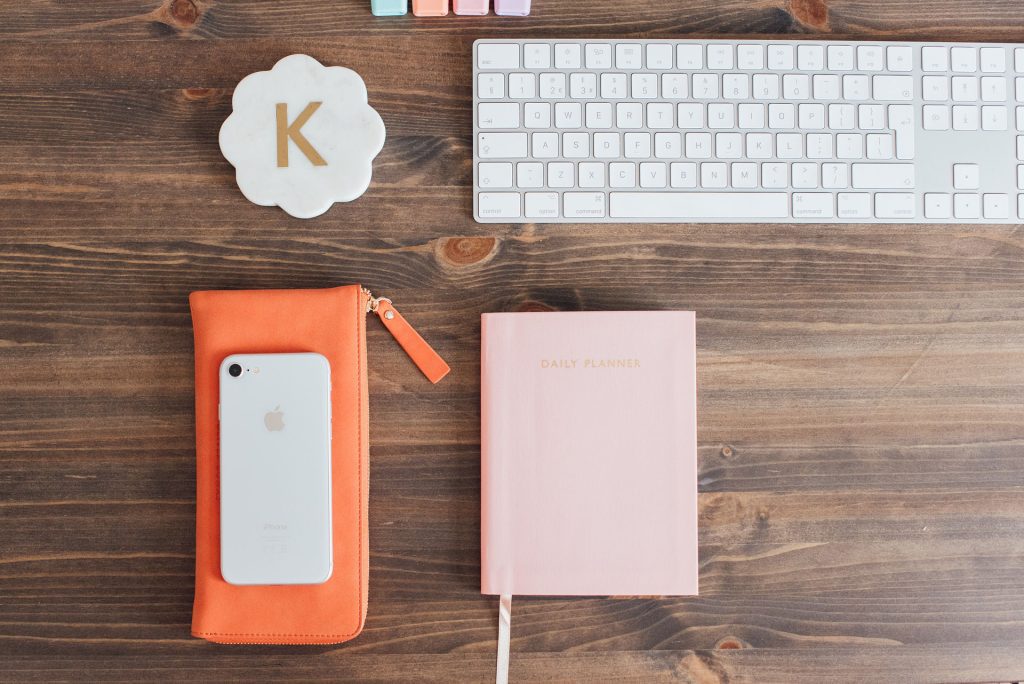 Keyboard, phone, daily planner and coaster with a K on it.