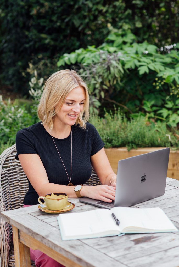 Kellie on lap top working virtually