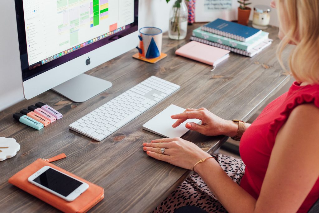 girl sat at computer using tracker pad