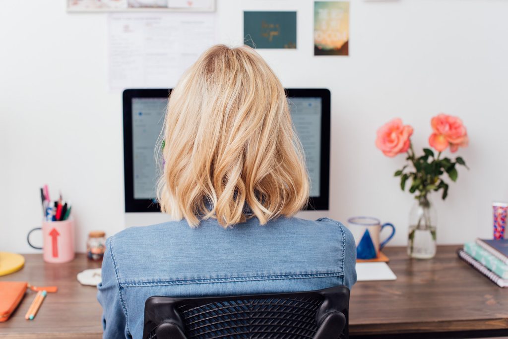 Girl at computer working on Asana