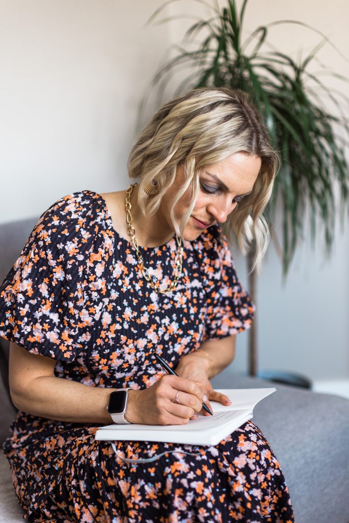 Kellie writing in a notebook