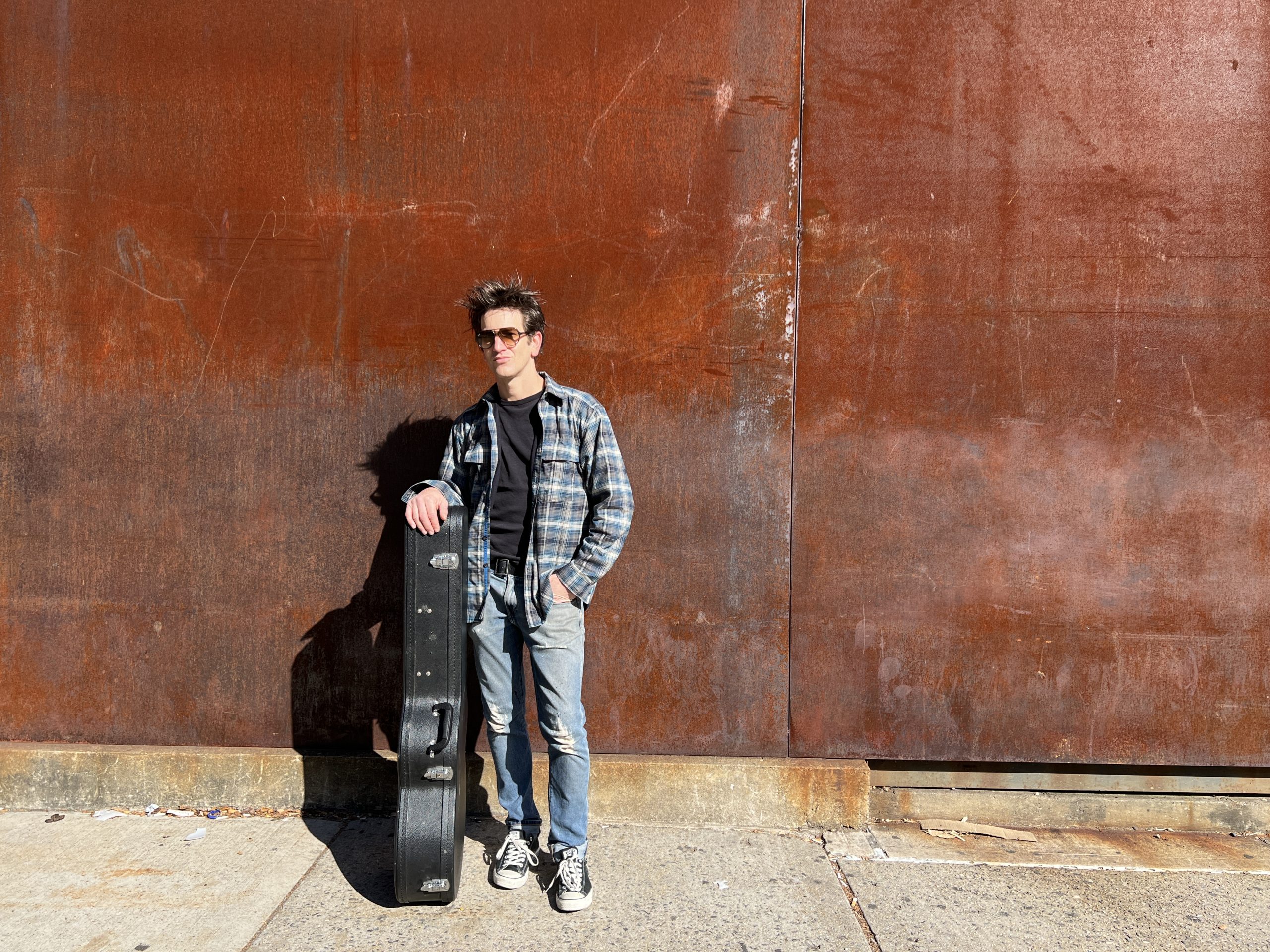 Gritty Indie Folk Singer Songwriter Dante Mazzetti with his acoustic guitar in his hometown of New York City, NY